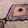 artisan-handwoven-moroccan-diamond-rug Slight angled front view highlighting the rug’s thick wool texture and vibrant tribal symbols.