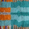 artisan-handwoven-moroccan-rug Middle section detail showing symmetrical tribal patterns and textured wool pile.