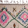 artisan-made-cream-moroccan-tribal-rug Full-length view of a handwoven Berber rug with decorative fringe edges.