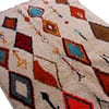 atlas-berber-handwoven-area-rug Bohemian Moroccan carpet with red, blue, orange, and brown shapes.