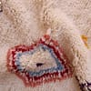 authentic-berber-tribal-rug-with-geometric-pattern Top section close-up showing the upper diamond motif and small floral accents.