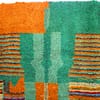 beni-ourain-inspired-geometric-rug Top section close-up showing upper green central motif with layered outlines.
