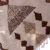beni-ourain-inspired-ivory-brown-rug Full-length vertical display of authentic Moroccan Beni Ourain style rug with diamond motifs.