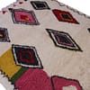 beni-ourain-inspired-multicolor-area-rug Top section close-up showing upper geometric shapes and bright pink border detail