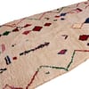 beni-ourain-style-geometric-area-rug Oblique side perspective showing thickness, softness, and colorful geometric design.