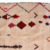 bohemian-moroccan-rug-with-diamond-motifs Full-length vertical display of artisan handmade Moroccan Berber carpet.