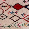 cream-boho-moroccan-area-rug Close-up of colorful geometric motifs on cream wool rug