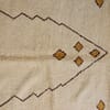 cream-geometric-moroccan-wool-rug-handwoven Top-down view of a cream Moroccan wool rug showing symmetrical diamond designs.