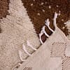 ivory-berber-rug-with-brown-geometric-pattern Bottom section view showing short fringes and handcrafted edge finishing.