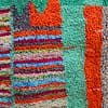 ivory-berber-rug-with-diamond-pattern Slight angled view highlighting thick high-pile wool texture and vibrant tribal design.