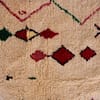 luxury-handwoven-moroccan-area-carpet Corner close-up of Moroccan area rug showing craftsmanship and stitching quality.