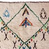 moroccan-berber-rug-with-green-lattice-design Close-up of the rug’s fringed edge and handcrafted weaving details.