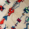 moroccan-wool-rug-cream-with-blue-pattern Cream tribal wool rug with colorful details top view