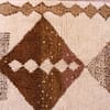 neutral-tone-moroccan-geometric-rug Close-up of large central brown diamond woven into soft ivory wool.