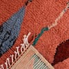 pink-beni-ourain-style-wool-rug Side angle view highlighting the thickness and soft pile of the pink Moroccan carpet.