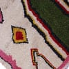 thick-pile-berber-rug-ivory-with-bright-motifs Right side close-up showing bold pink vertical block and yellow accent area.