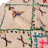 vibrant-berber-tribal-moroccan-carpet Overhead image focusing on diamond design and surrounding tribal symbols.