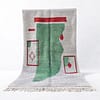 Abstract geometric rug with green features Full view of the Moroccan rug centered against a white background, showing the complete green and red geometric design.