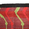 artisan-berber-rug-handwoven-morocco Corner detail close-up highlighting the rich red tones and dense wool craftsmanship.