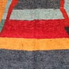 authentic-moroccan-tribal-shag-carpet Center close-up displaying large arch-inspired motif in red and green on dark background.