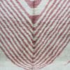 beni-ourain-area-rug-soft-pink-stripes Close-up of soft Berber wool rug with pink geometric patterns on cream background.