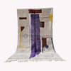 bohemian-modern-wool-carpet-geometric-art Full view of a handmade Moroccan Berber rug with a cream base and purple vertical stripe, displayed upright.