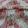 cozy-living-room-moroccan-rug White and pink Berber rug with soft wool texture and fringe detailing.
