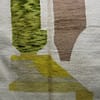 handmade-moroccan-rug-living-room Entire Moroccan wool rug with white background and earthy green, brown, and yellow tones.