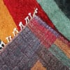 multicolor-berber-wool-living-room-rug Fringe detail showing hand-knotted tassels along the rug edge.