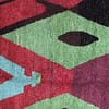 colorful-azilal-rug-geometric-berber-artisan Moroccan rug displayed from a diagonal angle showing depth and perspective