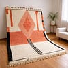 diamond-pink-rug Handmade Moroccan rug with burnt pink diamond pattern on a cream background with black accents