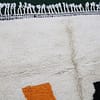 handmade-wool-rug-moroccan-abstract-art-design.jpg Close-up view of Moroccan wool rug showing soft texture and detailed pattern