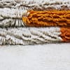 minimalist-moroccan-rug-abstract-geometric-pattern Partial close-up focusing on black and orange shapes in the rug