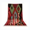 moroccan-berber-rug-red-green-abstract-wool Front view of Azilal rug standing upright with bold tribal design