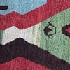 moroccan-handwoven-rug-colorful-diamond-pattern Side angle view of Moroccan rug highlighting thickness and texture
