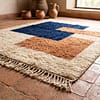 A_low-angle_close-up_of_a_rugmoroccan_rug_vertical_display_blue_cream_brown Handmade Cream Moroccan Rug: Berber Wool Rug, brown & blue Rugs, Boho Living Room Decor