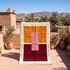Image-of-a-Moroccan-iron-rug-displayed-on-a-burnt-clay-surface Handmade Beni Ourain Wool Rug, Colorful Moroccan Geometric Area Rug
