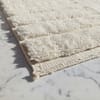 gemini-2.5-flash-image_A_close-up_photograph_of_a_handmade_Moroccan_wool_rug_laid_on_a_white_marble_flo-0 Custom Size Moroccan Beni M'rirt Rug, Ivory White carpet, High Pile Neutral Berber Carpet Living Room