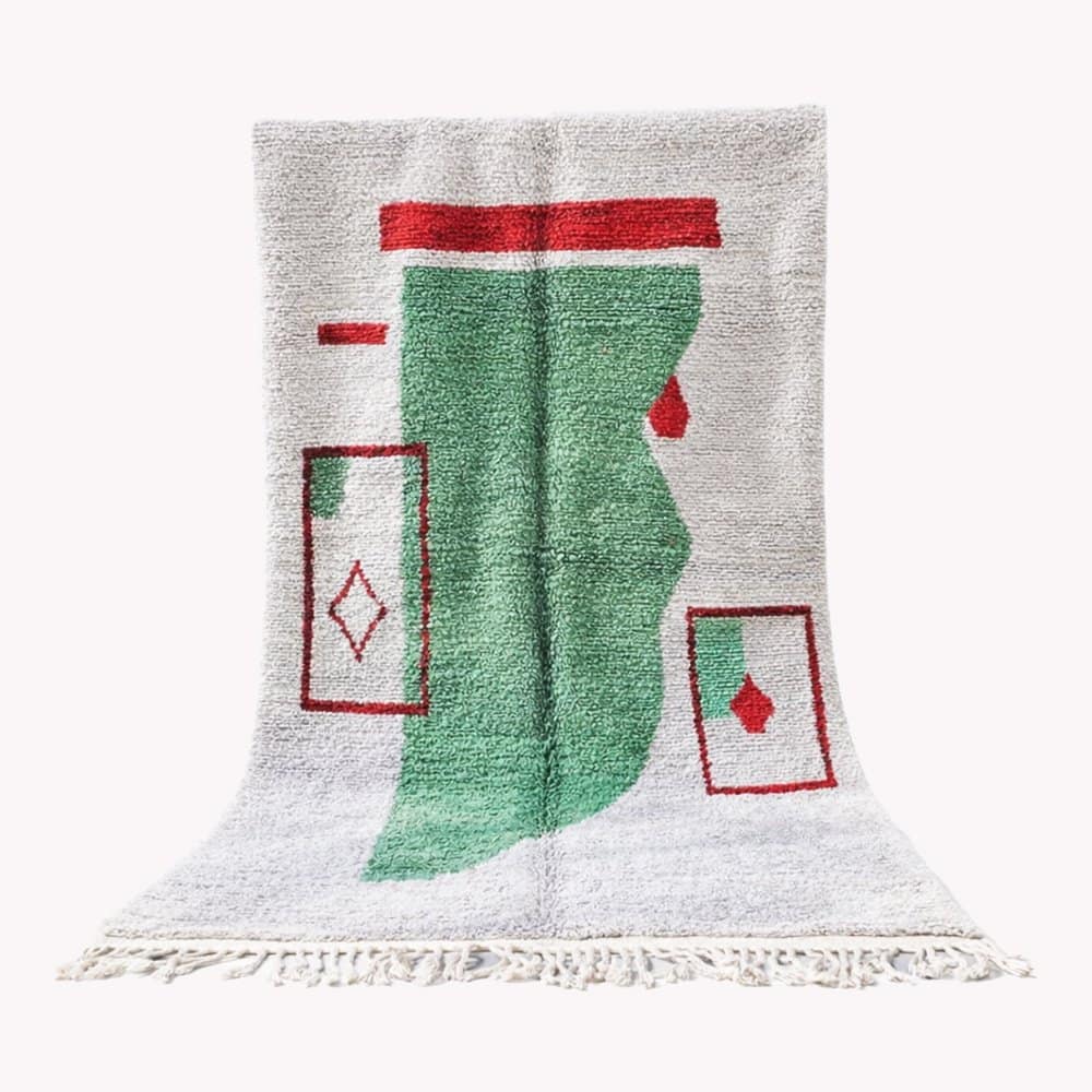 bohemian-handwoven-moroccan-carpet Full view of the Moroccan rug centered against a white background, showing the complete green and red geometric design.