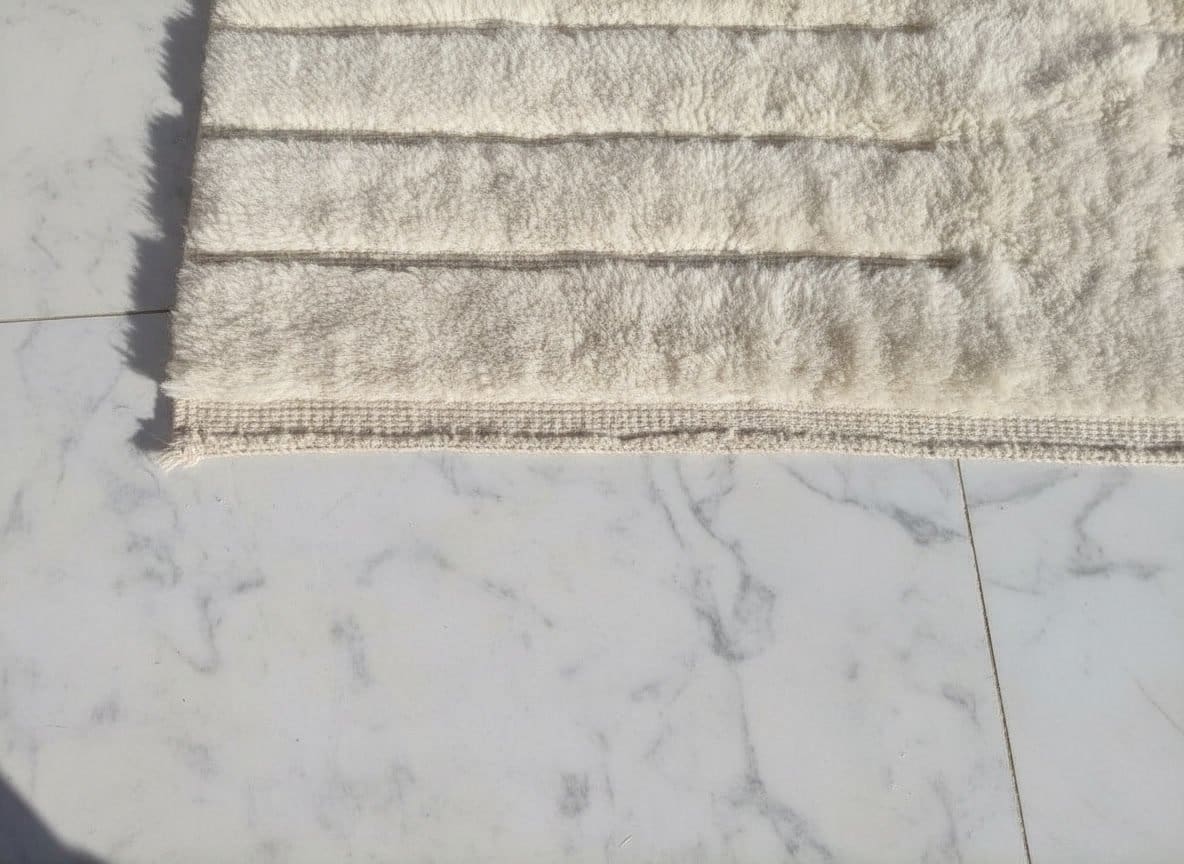gemini-2.5-flash-image_A_close-up_photograph_of_a_handmade_Moroccan_wool_rug_laid_on_a_white_marble_flo-0 (1) Custom Size Moroccan Beni M'rirt Rug, Ivory White carpet, High Pile Neutral Berber Carpet Living Room