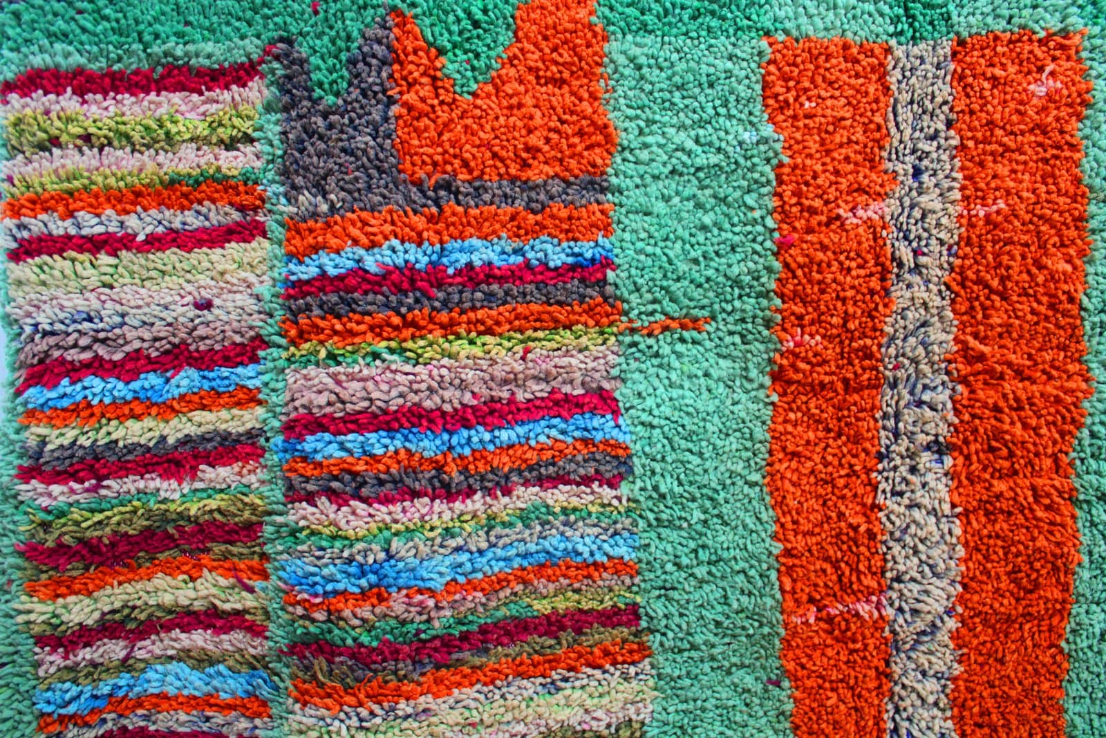 ivory-berber-rug-with-diamond-pattern Slight angled view highlighting thick high-pile wool texture and vibrant tribal design.