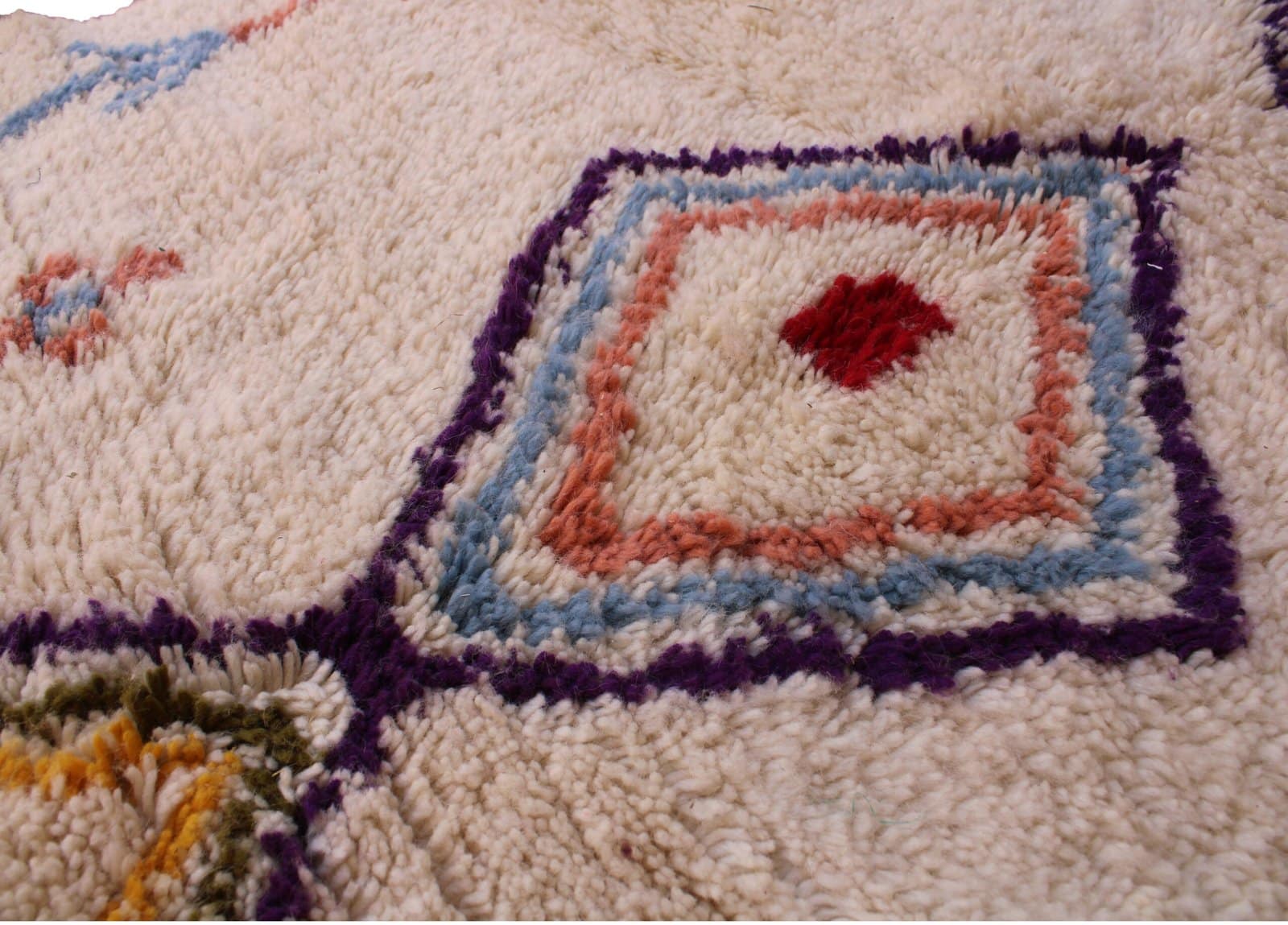 artisan-handwoven-moroccan-diamond-rug Slight angled front view highlighting the rug’s thick wool texture and vibrant tribal symbols.