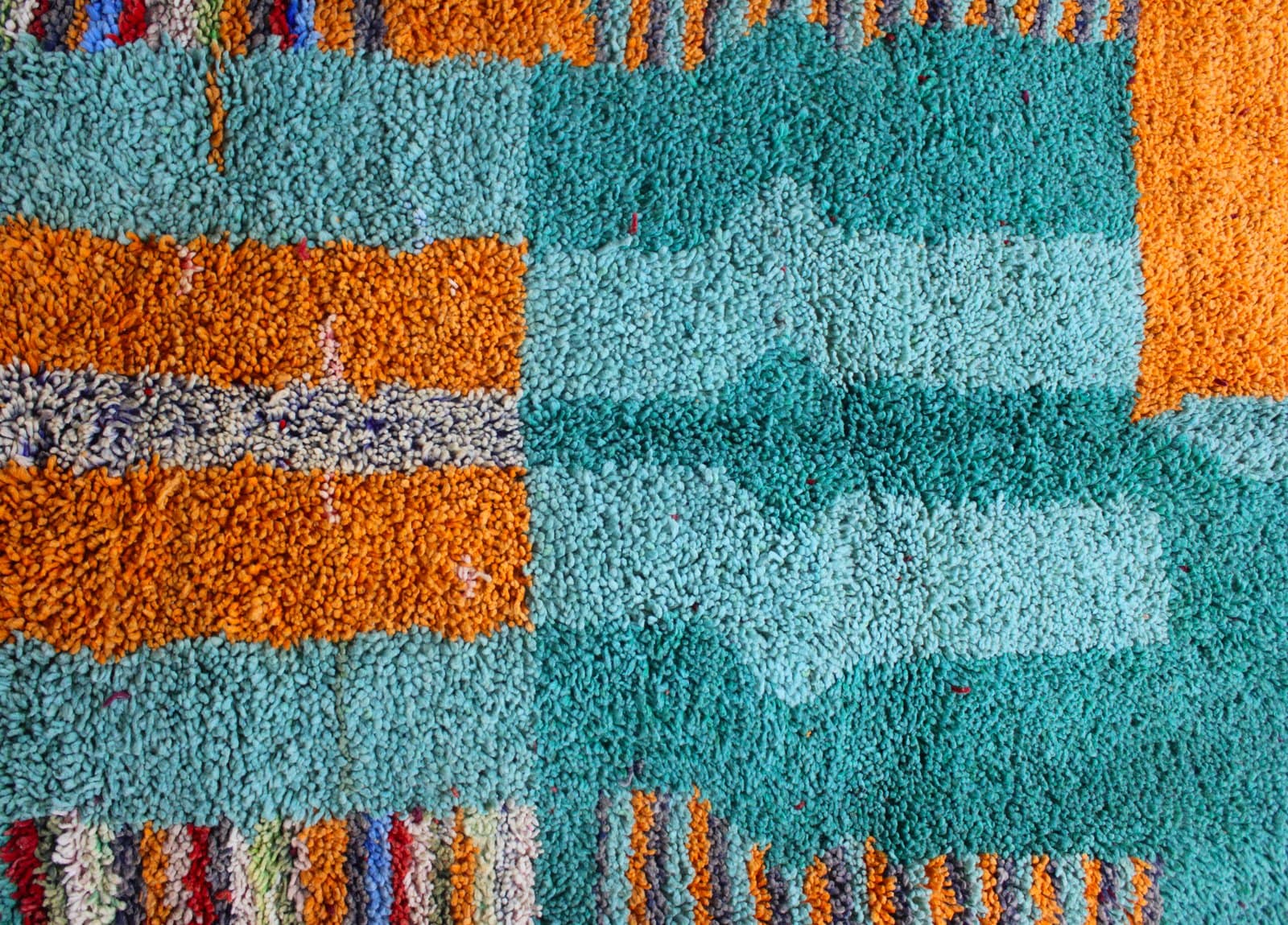 artisan-handwoven-moroccan-rug Middle section detail showing symmetrical tribal patterns and textured wool pile.