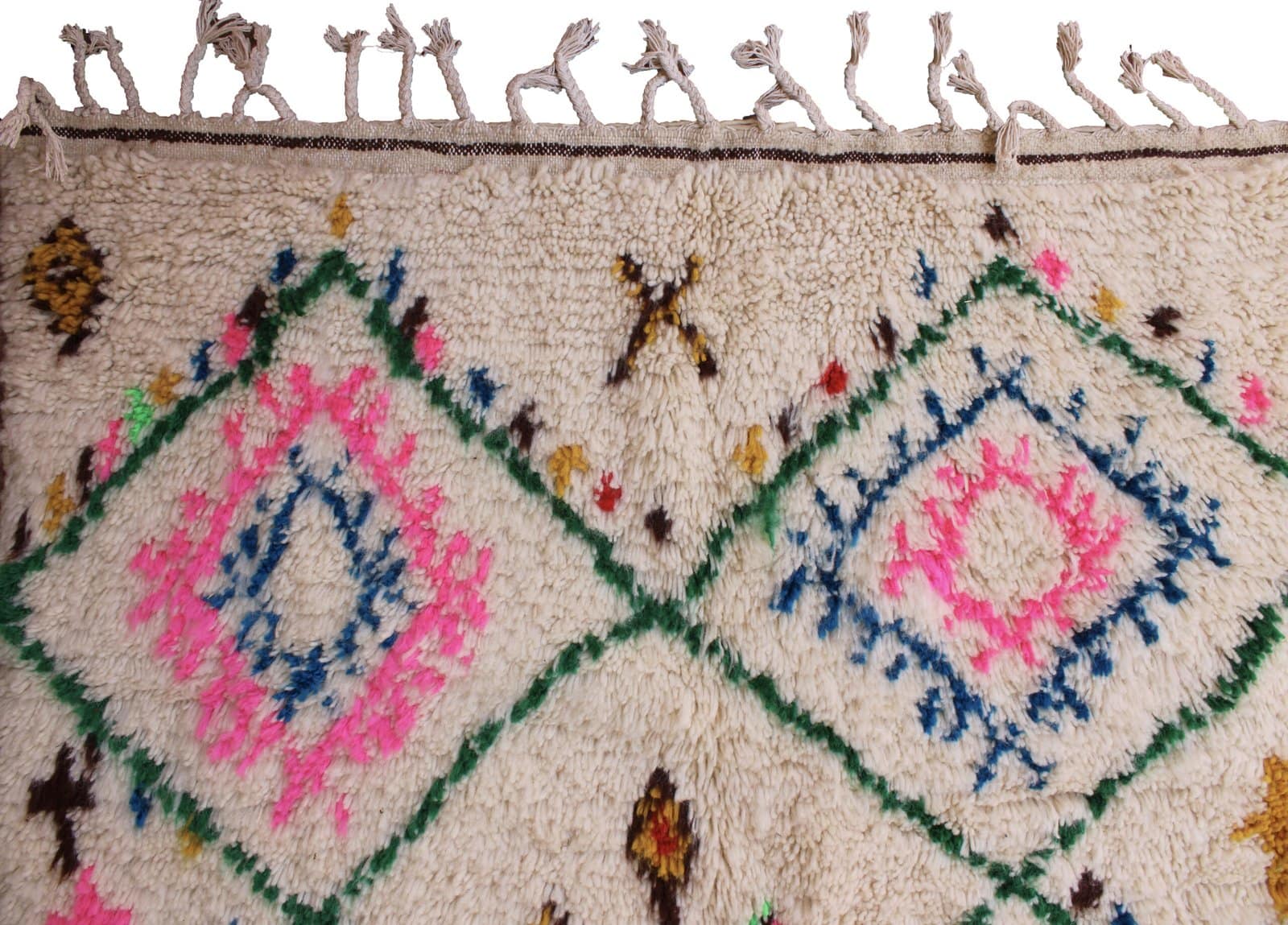artisan-made-cream-moroccan-tribal-rug Full-length view of a handwoven Berber rug with decorative fringe edges.