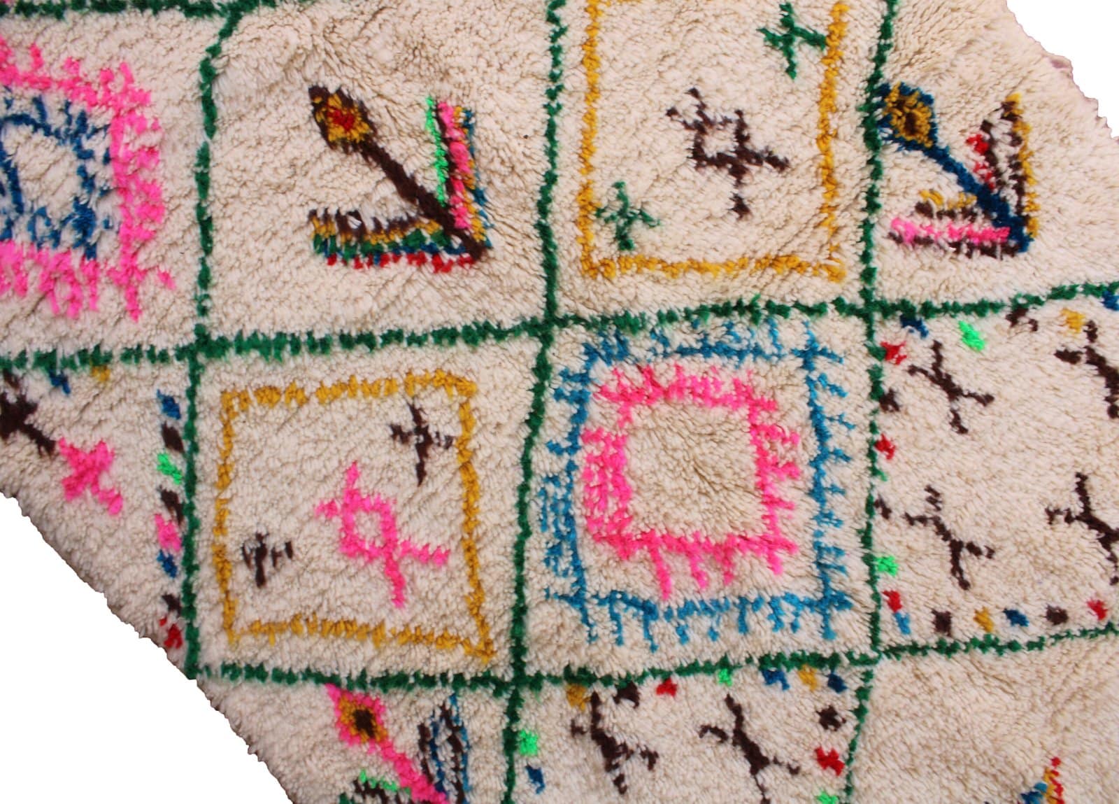 authentic-handwoven-moroccan-tribal-rug Detailed close-up of bright pink and blue diamond motifs on a cream wool background.