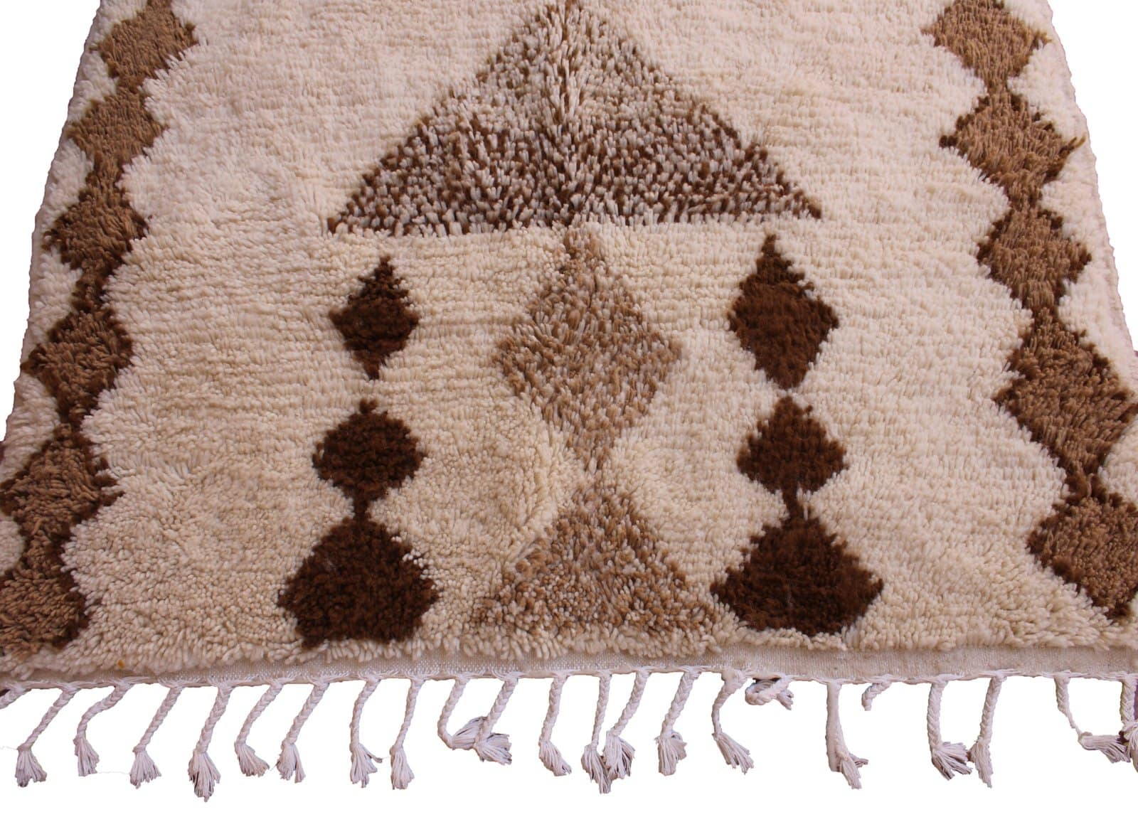 bohemian-moroccan-wool-area-rug Slight angled perspective of ivory and brown geometric area rug on white background.