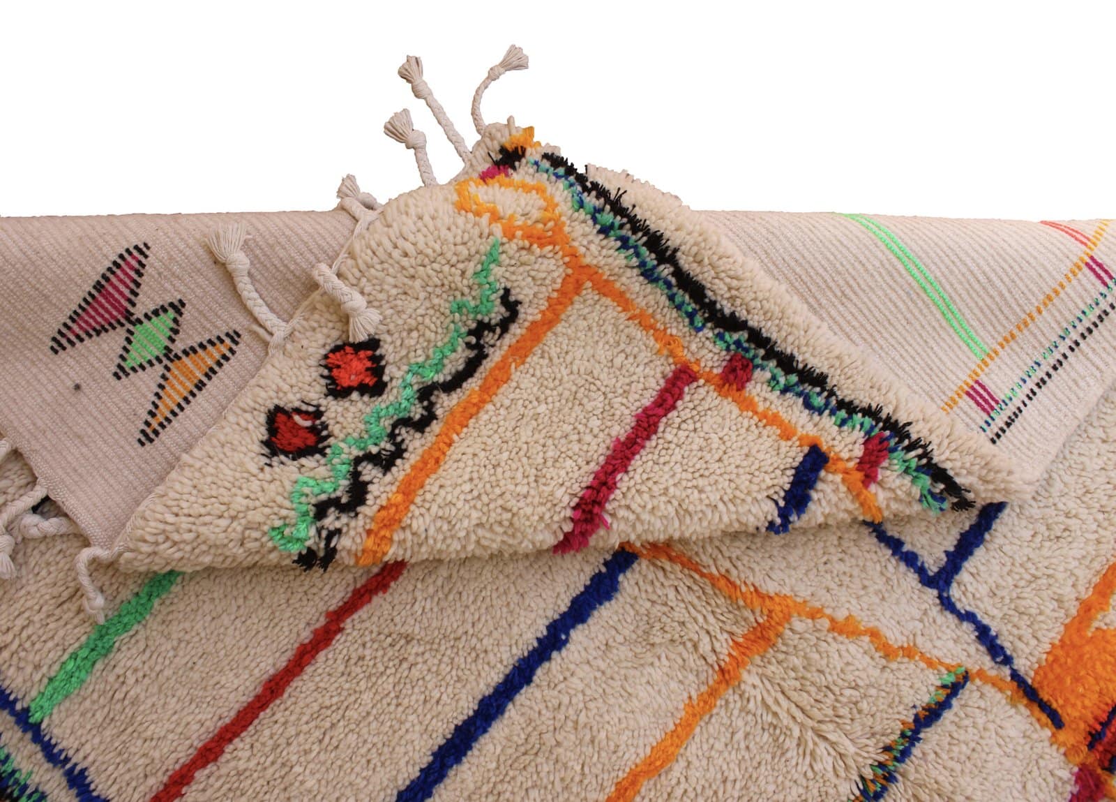cream-berber-rug-with-abstract-pattern Thick wool Berber carpet with red, blue, orange, and green accents.