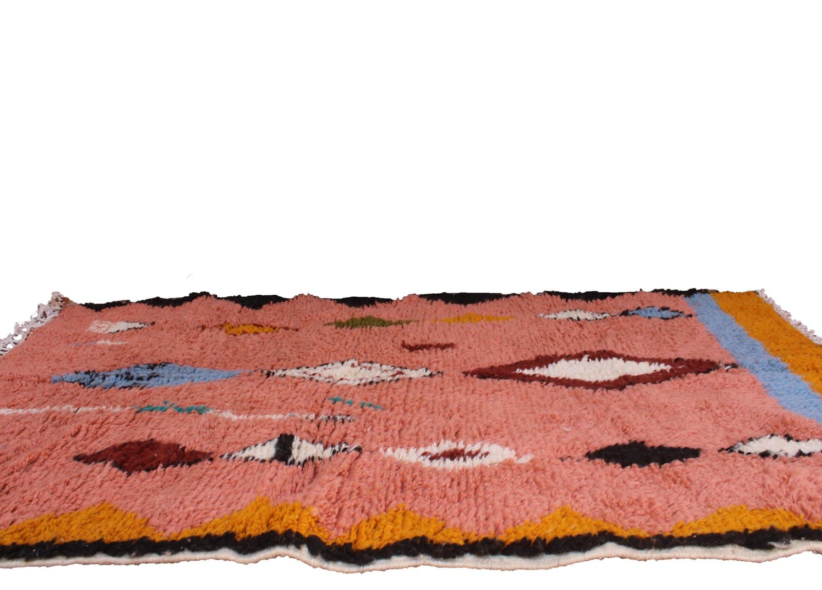 geometric-tribal-moroccan-wool-carpet Full-length shot of a coral Moroccan area rug with decorative fringe edges.