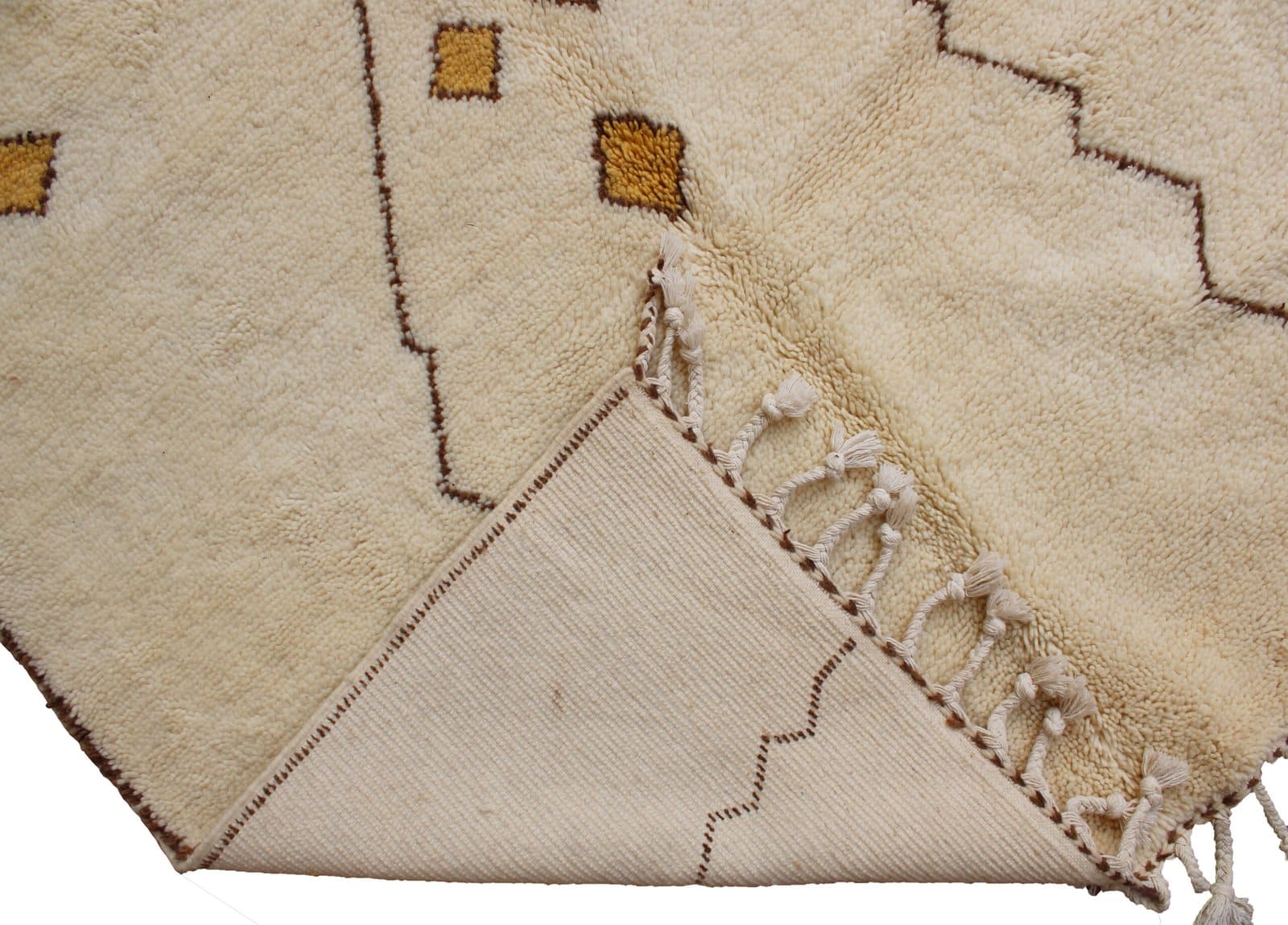 handwoven-cream-tribal-moroccan-rug Detailed close-up of yellow diamond accents woven into the ivory Moroccan rug.