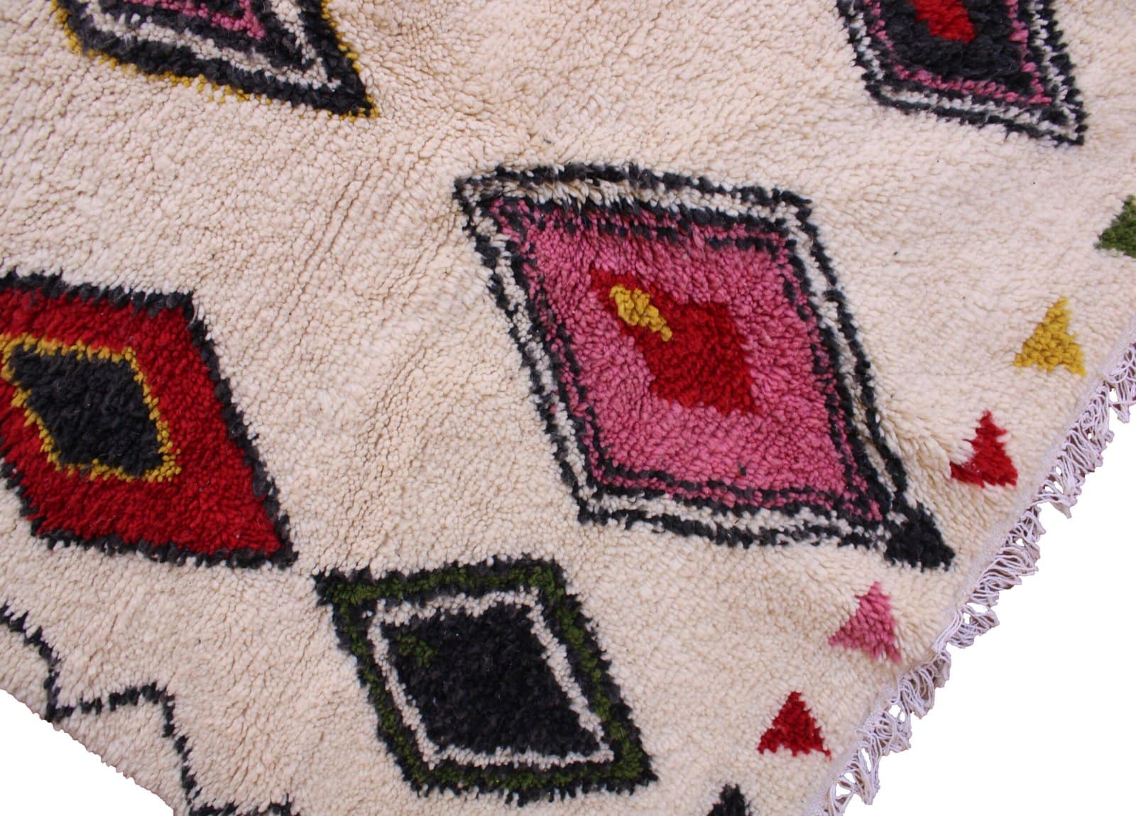 moroccan-boho-rug-with-vibrant-shapes Slight angled front view highlighting thick wool texture and vibrant red, pink, yellow, and green patterns.
